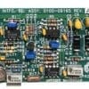 Green printed circuit board densely populated with resistors, capacitors, inductors, and ICs labeled U1, U2, R1–R23, used in electronic hardware; Applied Materials branding visible at bottom center.