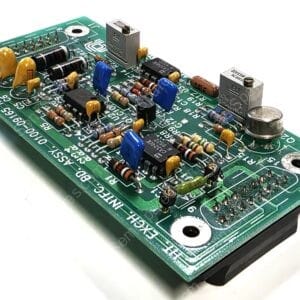 Green PCB populated with resistors, capacitors, ICs, and connectors, viewed at an angle