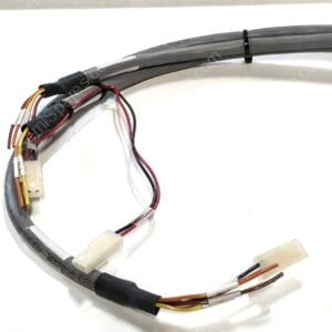 Close-up of a bundled multi-conductor electrical cable with color-coded wires (orange, yellow, red, brown) and white connector housings, some sections covered in black heat-shrink tubing.