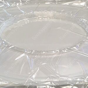 Clear plastic wrap laid over a white surface, with a circular raised area in the center (a tray or mold).] ,