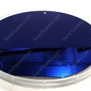 Close-up of a round white-framed object with a dark blue lens, viewed from above or at an angle.