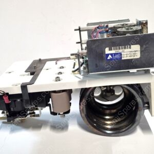 Close-up of a precision lab/industrial device with a large wheel, metal housing, and exposed wiring on a white surface