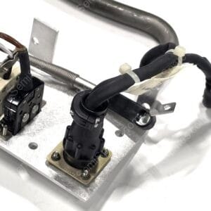 Close-up of an electrical mounting on a metal panel with a terminal block, wires, and cable clamps.