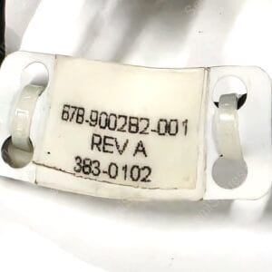 White plastic mounting/bracket with stamped serial-like text, shown in gloved hands; labeled REV A.
