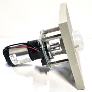 Close-up of a small electric motor mounted to a metal frame with red and black wires and a green circuit board nearby, on a white background.