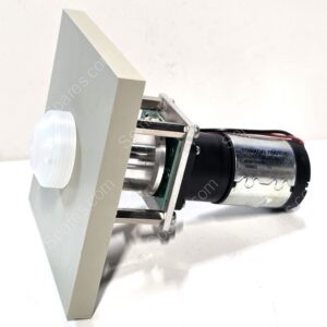 Close-up of a small electric motor mounted on a metal frame with a white circular knob nearby.