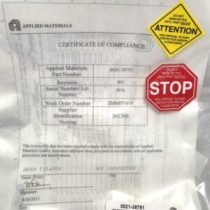 Certificate of compliance from Applied Materials on a bag, with a yellow attention sticker and a red STOP sticker overlapping the document for part protection and handling warnings.