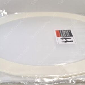 New white round toilet seat still wrapped in clear plastic packaging with a warning label on top