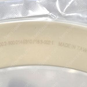 Close-up of a beige curved plastic surface with a white 'Laser Mark Here' label and clear packaging tape above.