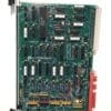 Green PCB populated with DIP ICs and a right-edge connector; 'Applied Materials' logo visible on the board edge.