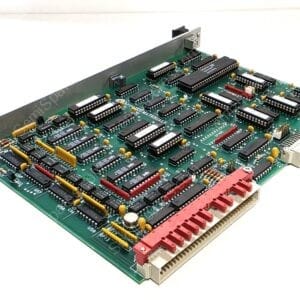 Printed circuit board with many DIP ICs, yellow capacitors, and a large edge connector, viewed at an angle.