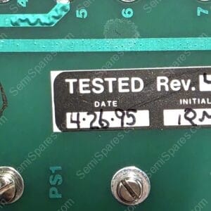 Close-up of a green panel with a black 'TESTED Rev.' label showing the date 4 26 95 and initials, with screws nearby and a circular stamp on the left.
