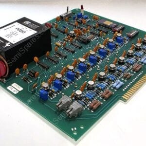 Vintage green motherboard with a large black transformer, many orange capacitors, blue trimmers, DIP ICs, and a gold edge connector on the right; retro electronics board image.