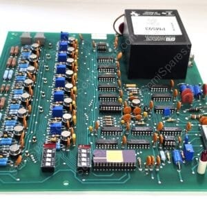 Green circuit board densely populated with capacitors, resistors, ICs, and an edge connector on the left; a large black module sits top-right.