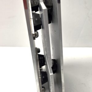 Close-up of a metal mounting bracket with rotating cam locks and black plastic components inside.