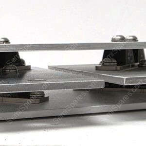 Close-up of a metal two-plate clamp with spacers and rounded screws, mounted on a flat base (precision alignment fixture).