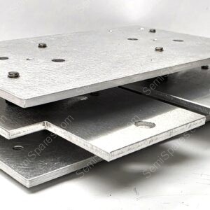 Stack of silver metal plates with holes and bolts, stacked like a small staircase (industrial hardware).