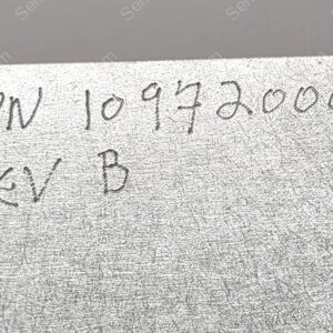 Close-up of a textured metal surface with engraved alphanumeric code PIN 10932001 and a circular screw at the bottom-left.