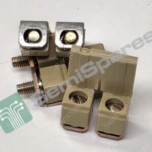 Close-up of two silver square terminal blocks with recessed screw holes on a beige plastic connector, showing exposed screw heads and wiring area behind."