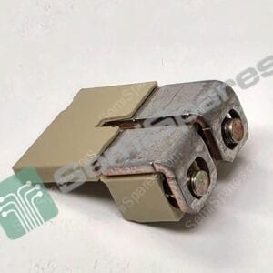 Close-up of a metal hinge or clamp with two large screws and a beige mounting plate on a light surface, with a teal circuit-pattern label partially visible nearby.