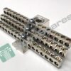Metal perforated mounting bars with evenly spaced circular holes and screws, used as industrial hardware supports on a white surface.