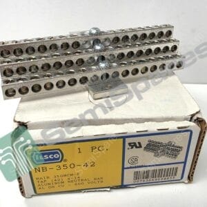 Stack of perforated metal terminal blocks with many screw terminals, placed on a white surface over a cardboard box.