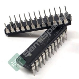 Close-up of a black DIP IC with many metal pins extending from its sides; shows one edge of the package.