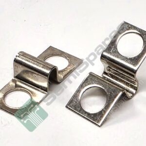 Close-up of shiny metal electrical lug connectors with circular holes, laid on a white surface