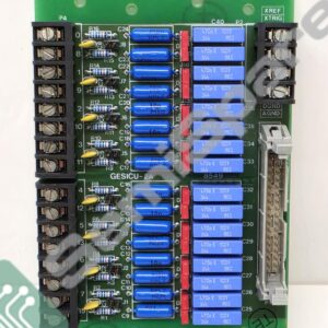 Green PCB populated with blue rectangular capacitors, resistors, and two black terminal blocks on sides; labeled GESICU-2A, XREF/XTRIG on right.