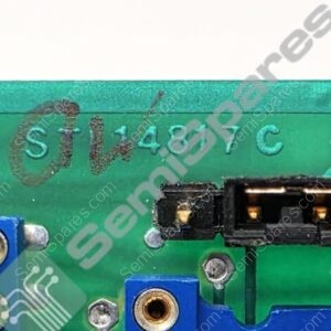 Close-up of a green printed circuit board showing a black connector and blue screw-terminal blocks.