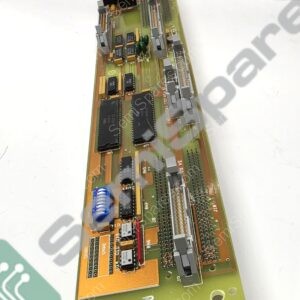 Green PCB with edge connectors, DIP sockets, capacitors, and IC chips visible in a close-up view.
