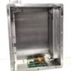 Interior of a metal electrical cabinet with a green PCB, resistors and capacitors mounted along the bottom inside the frame