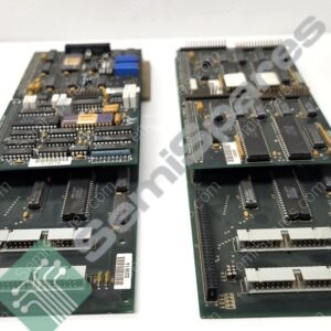 Two vintage circuit boards with numerous DIP chips and edge connectors laid on a white surface.