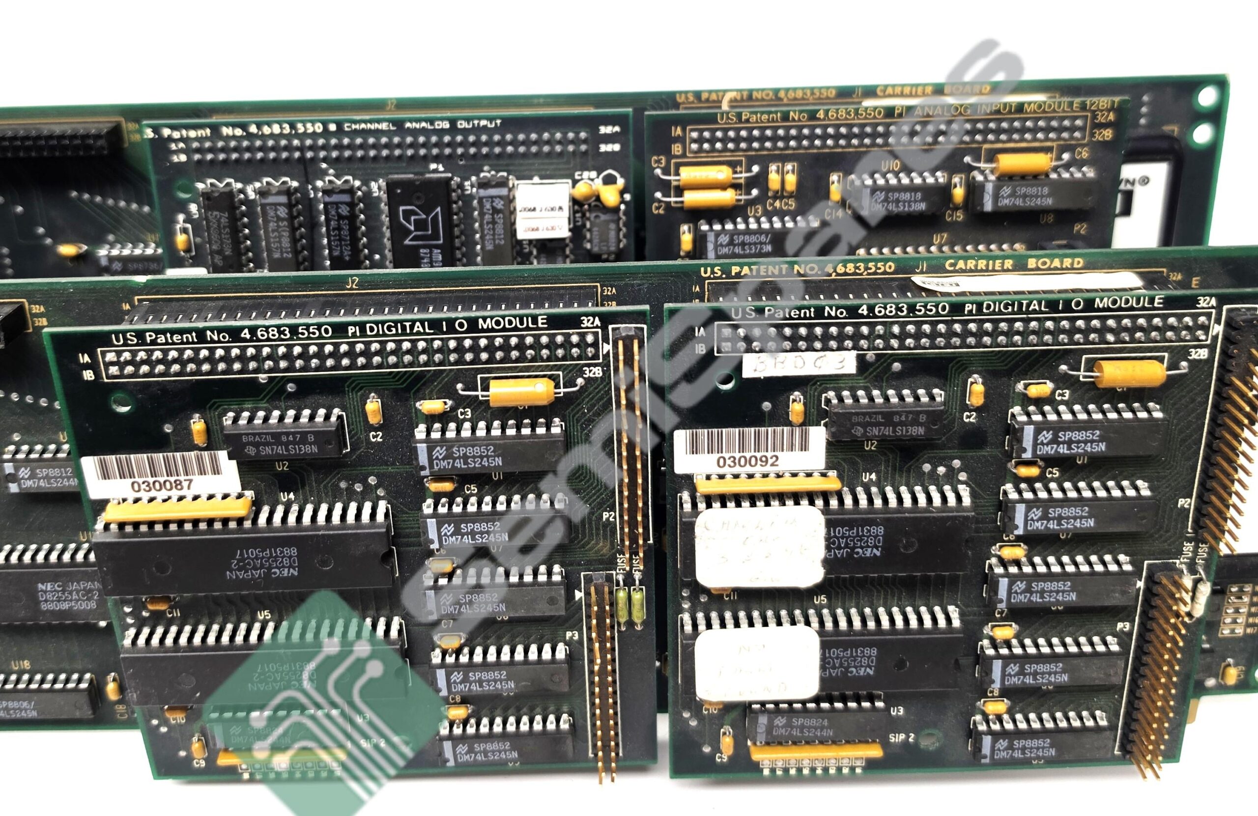 Close-up of stacked vintage printed circuit boards with DIP chips, yellow capacitors, and edge connectors used in old hardware