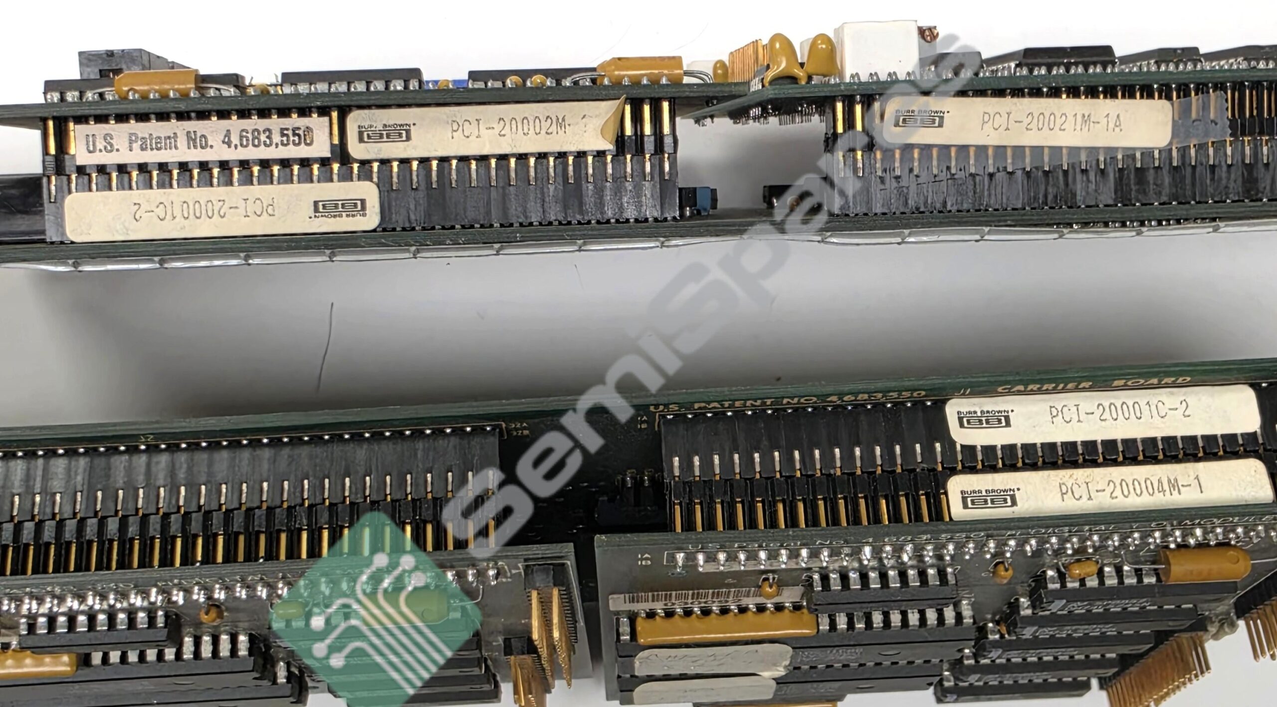 Close-up of vintage IBM PCI expansion cards with gold edge connectors and printed labels such as PCI-2000M-1A and U.S. Patent No. 4,683,550.