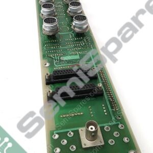 Green PCB module with multiple circular 8-pin metal connectors along one edge, plus black sockets and soldered traces (industrial control board).