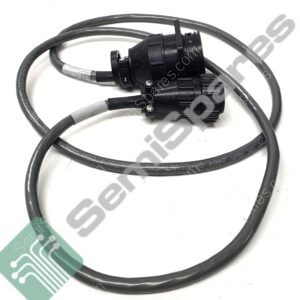 Close-up of a black circular electrical connector with attached cables and metal crimps.