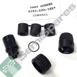 Close-up of black plastic mechanical adapters/rings laid on a white surface, with a card showing PART NUMBER 6282-6PG-3XX CONXAL.