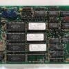 Dense green circuit board filled with numerous DIP ICs, resistors, capacitors, and edge connector on the right; clearly labeled components indicate a vintage computer or arcade board.
