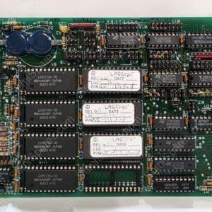 Dense green circuit board filled with numerous DIP ICs, resistors, capacitors, and edge connector on the right; clearly labeled components indicate a vintage computer or arcade board.