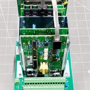 Industrial PLC/module with green terminal blocks and stacked circuit boards, viewed from above
