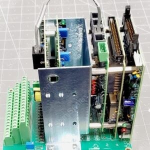 Open industrial control module showing blue PCBs, edge connectors, and green terminal blocks inside a metal chassis.