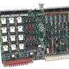 Large industrial circuit board with densely packed chips, capacitors, and a red edge connector along the bottom edge, populated with connectors and components.