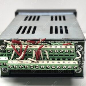 Close-up of a green terminal block with numbered screw terminals (1–26) and red/white wires in an electrical control panel.