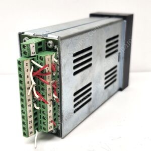 Industrial control module with a green terminal block and white wires mounted on a metal enclosure; functional wiring panel.