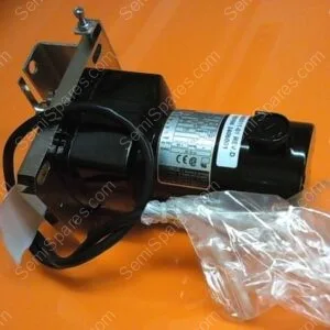 Electric motor with a metal mounting bracket and exposed wires on an orange background, plus a plastic bag with hardware nearby.