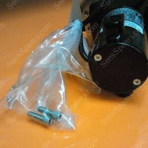 Electric motor mounted to a frame with a clear plastic bag containing screws resting on an orange floor.