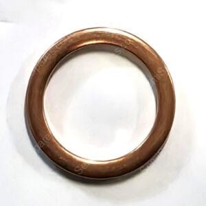 Copper wedding band with a smooth, rounded edge resting on a white surface.
