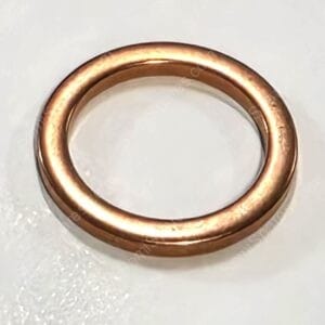 Copper wedding band ring on a light background, simple smooth design.