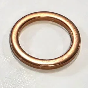 Copper wedding band ring on a light background, simple smooth design.